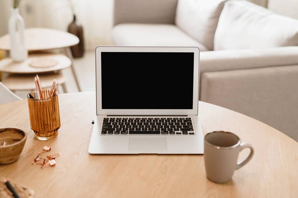 laptop on table in living room. best jobs that pay weekly.